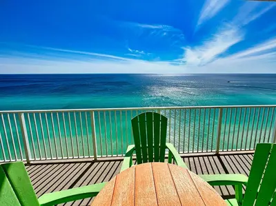 a table and chairs on a balcony with the ocean at Ocean Reef 2303 in Panama City Beach