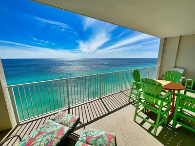 a balcony with a table and chairs and the ocean at Ocean Reef 2303 in Panama City Beach
