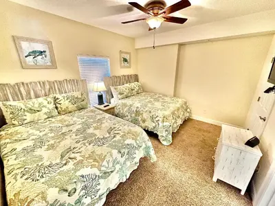 a bedroom with a bed and a ceiling fan at Ocean Reef 703 in Panama City Beach
