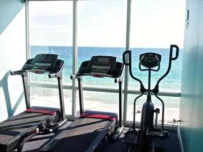 a gym with two exercise bikes in front of a window at Ocean Reef 703 in Panama City Beach