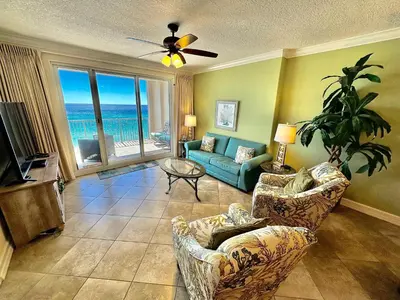 a living room with a view of the ocean at Ocean Reef 703 in Panama City Beach
