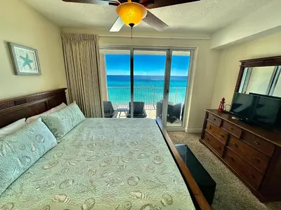 a bedroom with a bed with a view of the ocean at Ocean Reef 703 in Panama City Beach