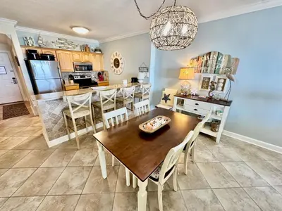 a kitchen and dining room with a table and chairs at Ocean Reef 1102 in Panama City Beach