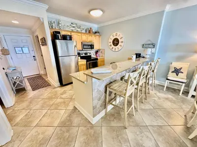 a kitchen with a large island with a counter top at Ocean Reef 1102 in Panama City Beach