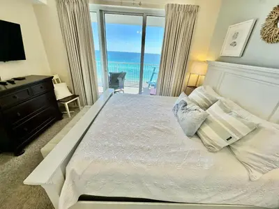 a bedroom with a bed with a view of the ocean at Ocean Reef 1102 in Panama City Beach