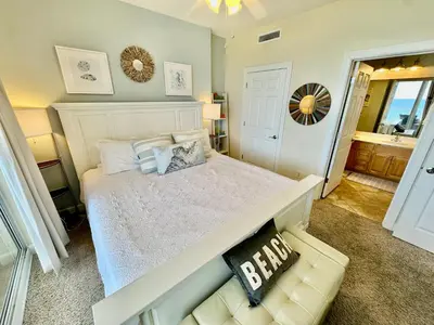 a bedroom with a white bed and a couch at Ocean Reef 1102 in Panama City Beach