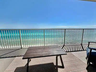 a bench on a balcony with the ocean at Ocean Reef 1102 in Panama City Beach