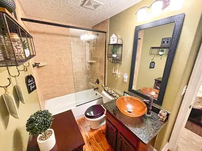 a bathroom with a sink and a bath tub at Ocean Reef 1609 in Panama City Beach