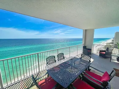 a balcony with a table and chairs and the ocean at Ocean Reef 1609 in Panama City Beach