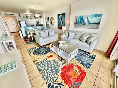 a living room with a couch and a table at Tropic Winds 2302 in Panama City Beach