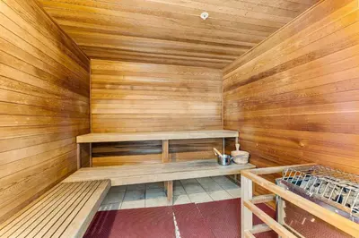 a sauna with wooden walls and a bench in it at Tropic Winds 2302 in Panama City Beach