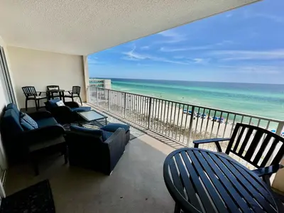 a balcony with chairs and a view of the beach at Ocean Reef 606 in Panama City Beach