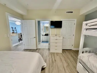 a bedroom with a bed and a television in it at Ocean Reef 1006 in Panama City Beach