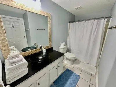 a bathroom with a sink and a toilet and a shower at Ocean Reef 1006 in Panama City Beach
