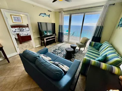 a living room with a blue couch and a television at Ocean Reef 1507 in Panama City Beach