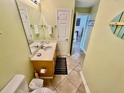 a bathroom with a sink and a mirror at Ocean Reef 1507 in Panama City Beach