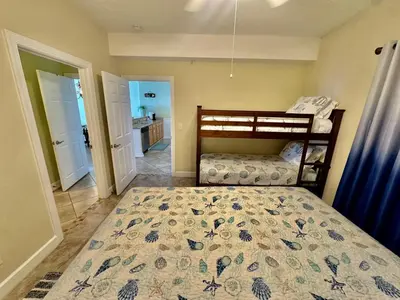 a bedroom with a bed with a bedspread on it at Ocean Reef 1507 in Panama City Beach