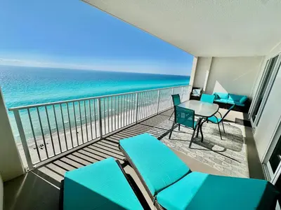 a balcony with chairs and a table and the ocean at Ocean Reef 1507 in Panama City Beach