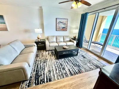 a living room with a couch and a table at Tropic Winds 1806 in Panama City Beach