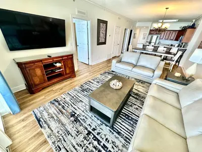 a living room with a couch and a tv at Tropic Winds 1806 in Panama City Beach