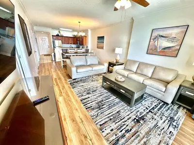 a living room with a couch and a table at Tropic Winds 1806 in Panama City Beach