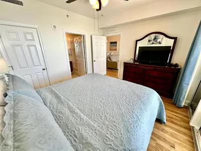 a bedroom with a bed and a flat screen tv at Tropic Winds 1806 in Panama City Beach
