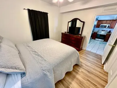 a bedroom with a bed and a mirror and a television at Tropic Winds 1806 in Panama City Beach