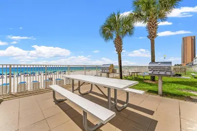 a picnic table with a view of the beach at Tropic Winds 1806 in Panama City Beach