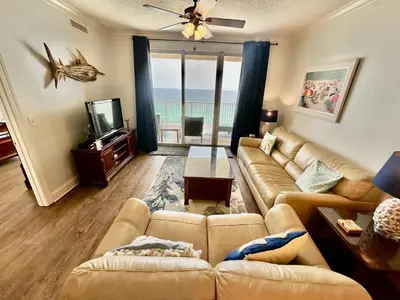 a living room with a couch and a television at Tropic Winds 1401 in Panama City Beach