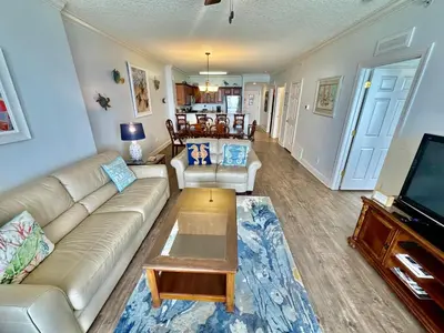 a living room with a couch and a coffee table at Tropic Winds 1401 in Panama City Beach