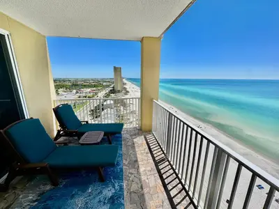 a balcony with two chairs and the ocean at Tropic Winds 1401 in Panama City Beach