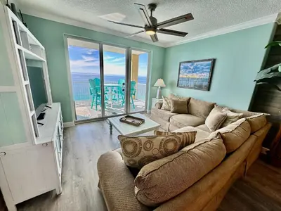 a living room with a couch and a view of the ocean at Tropic Winds 2209 in Panama City Beach
