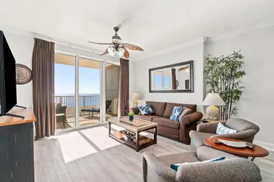 a living room with a couch and a table at Tropic Winds 1901 in Panama City Beach