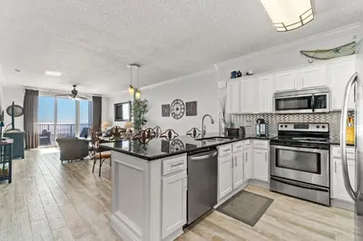 a kitchen with white cabinets and stainless steel appliances at Tropic Winds 1901 in Panama City Beach