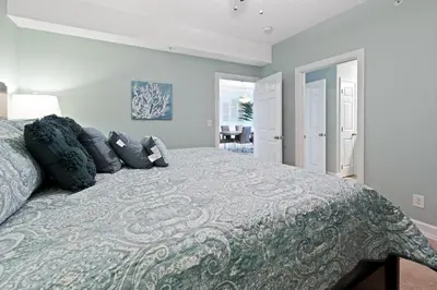 a bedroom with a large bed with pillows on it at Ocean Reef 1101 in Panama City Beach