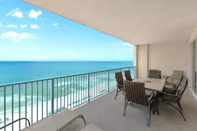 a balcony with a table and chairs and the ocean at Ocean Reef 1101 in Panama City Beach