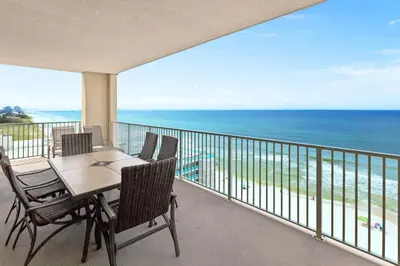 a balcony with a table and chairs and the ocean at Ocean Reef 1101 in Panama City Beach