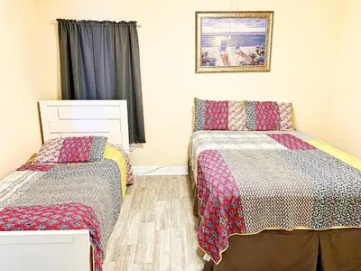 a bedroom with two beds and a picture on the wall at Tropic Winds 801 in Panama City Beach