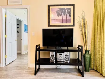 a living room with a television on a table at Tropic Winds 801 in Panama City Beach