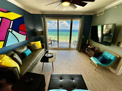 a living room with a couch and a view of the ocean at Ocean Reef 604 in Panama City Beach