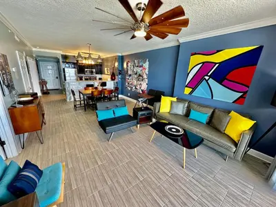a living room with a couch and a dining room at Ocean Reef 604 in Panama City Beach