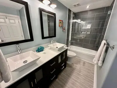 a bathroom with two sinks and a toilet and a shower at Ocean Reef 604 in Panama City Beach