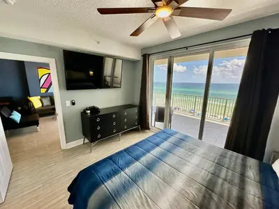 a bedroom with a bed and a view of the ocean at Ocean Reef 604 in Panama City Beach