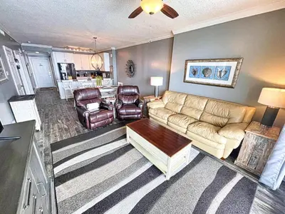 a living room with a couch and a table at Tropic Winds 1604 in Panama City Beach