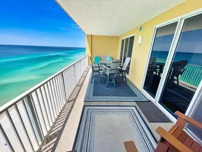 a balcony with a table and chairs and the ocean at Tropic Winds 1604 in Panama City Beach