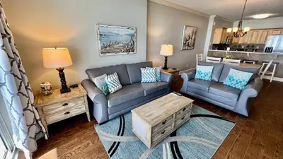 a living room with two couches and a coffee table at Tropic Winds 1609 in Panama City Beach