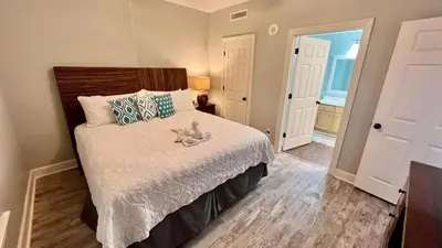 a bedroom with a bed with a stuffed animal on it at Tropic Winds 1609 in Panama City Beach
