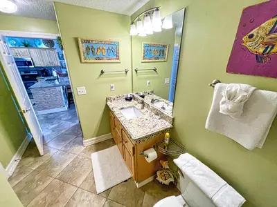 a bathroom with a sink and a mirror at Tropic Winds 1406 in Panama City Beach