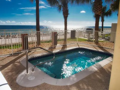 a swimming pool with a view of the ocean at Tropic Winds 1406 in Panama City Beach
