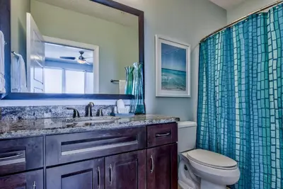 a bathroom with a sink and a toilet and a shower at Tropic Winds 703 in Panama City Beach